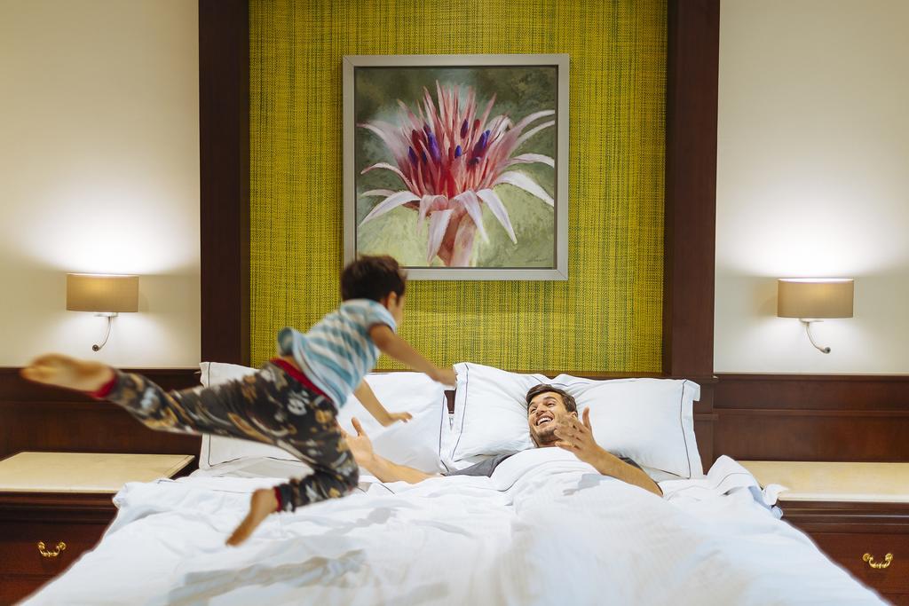 Occidental At Xcaret Destination Hotel Xcaret Park Екстериор снимка A child jumps on a bed.